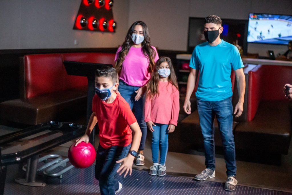 family bowling with masks